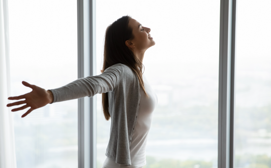 A women breathing clean fresh air indoors.